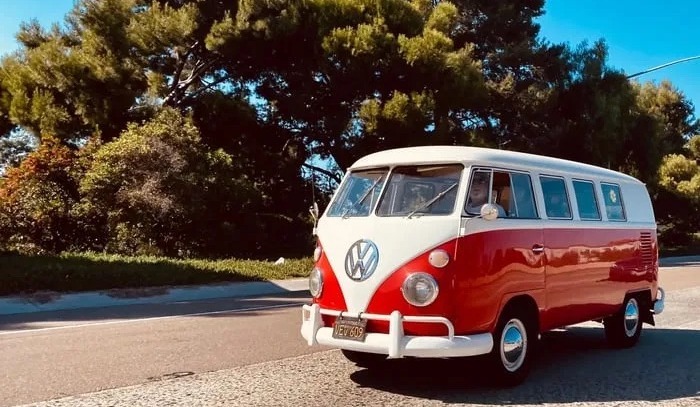 THE Red Van in motion on a sunlit road-1