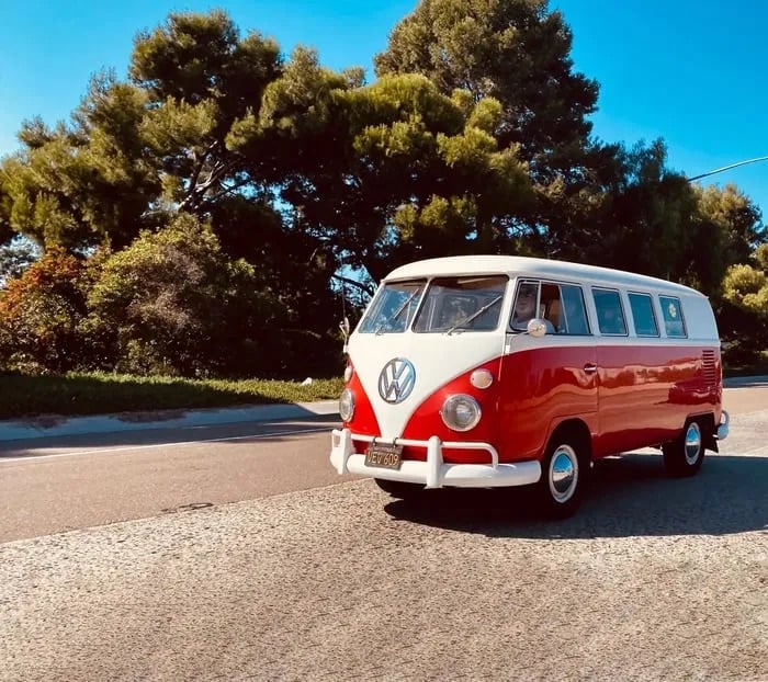THE Red Van in motion on a sunlit road